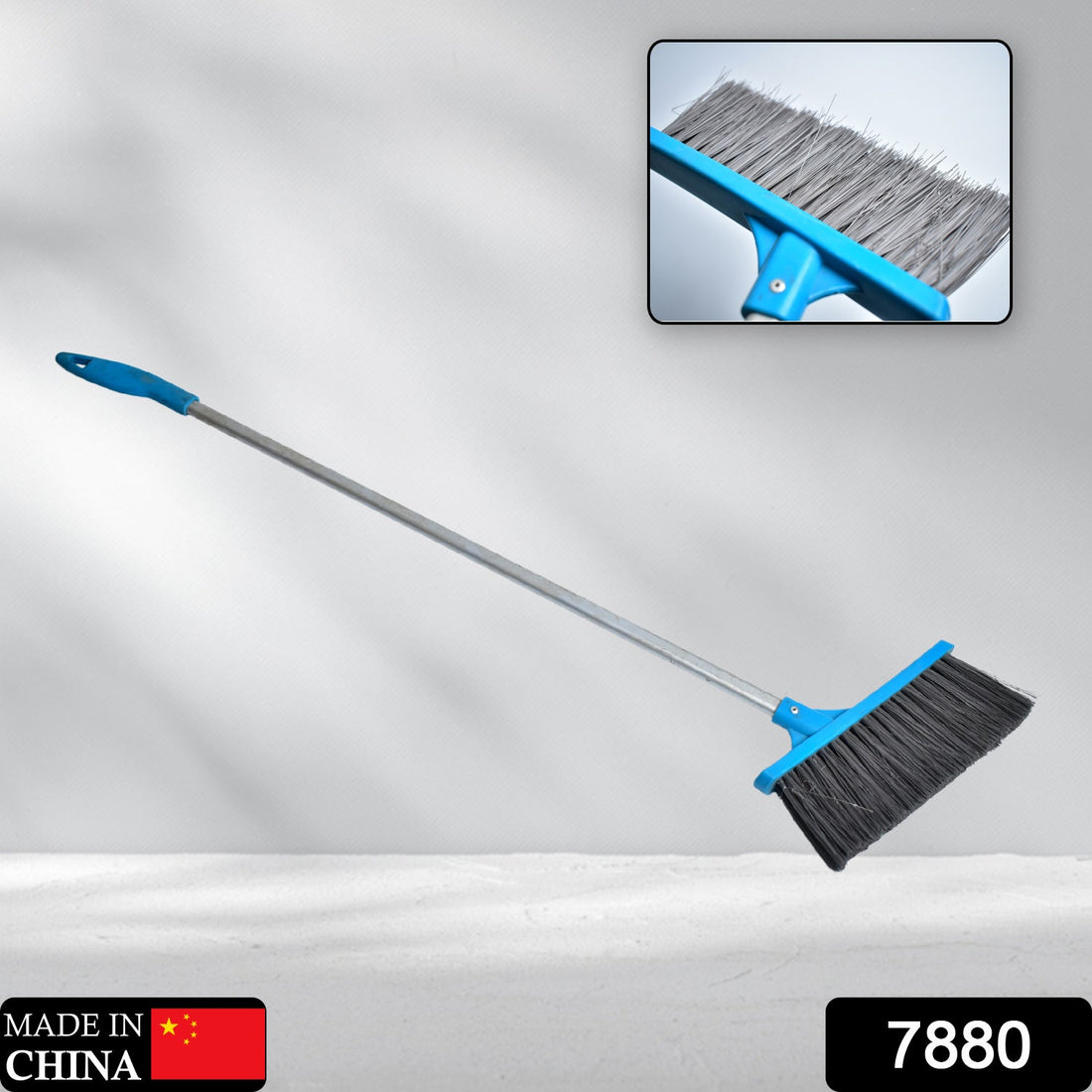 Long-handle floor scrub brush with stiff bristles for cleaning showers and tiles.