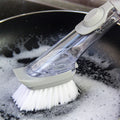 Long handle dishwashing brush resting on a counter, demonstrating its size and design.