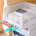 Foldable 3-layer organizer for clothes, ideal for use in wardrobes or cupboards.