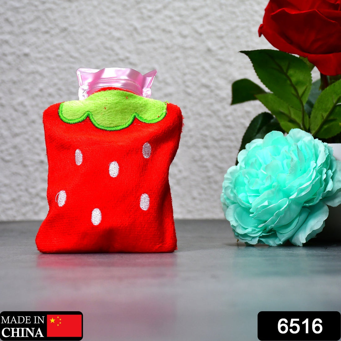 Mini hot water bag with strawberry design for neck and shoulder pain.