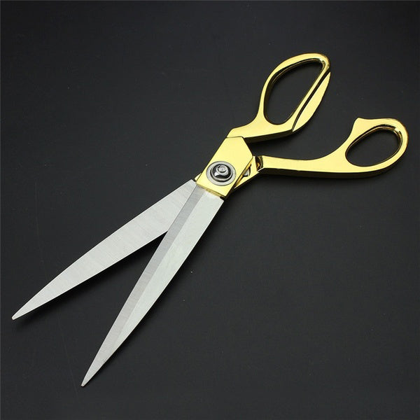 Elegant gold scissors for professional cloth cutting.