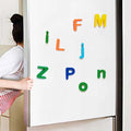 Colorful magnetic letters on a whiteboard