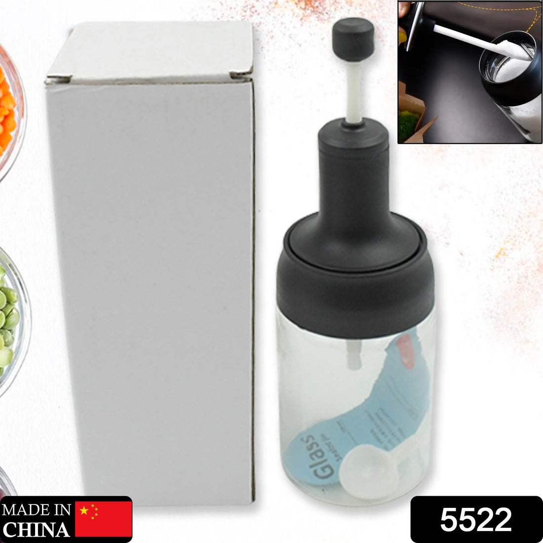 Heat-resistant glass seasoning jar with spoon for kitchen use.