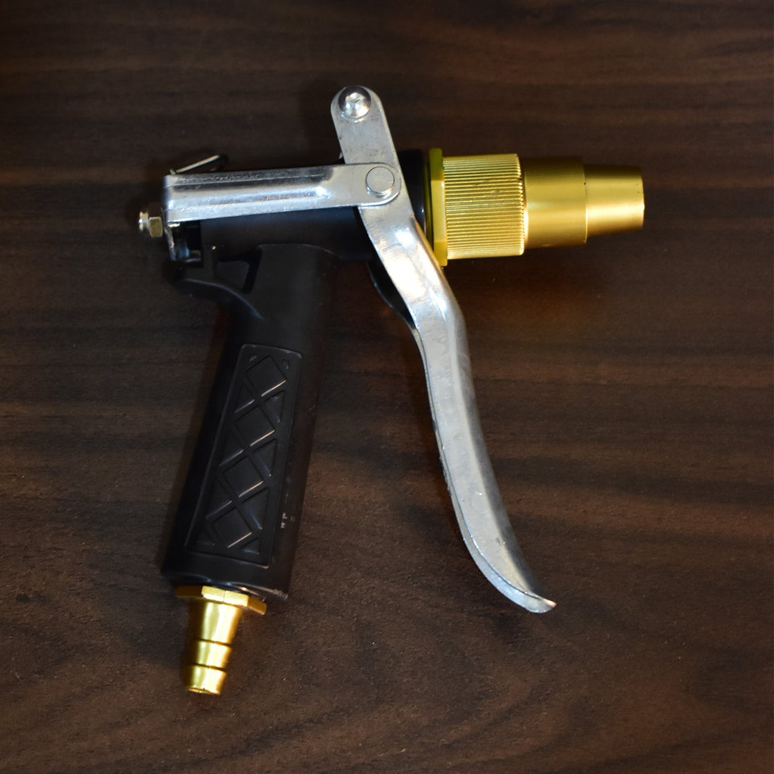 Gold color trigger hose nozzle, durable design for water spraying.