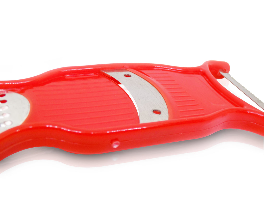 Multi-purpose vegetable peeler and grater for kitchen use.